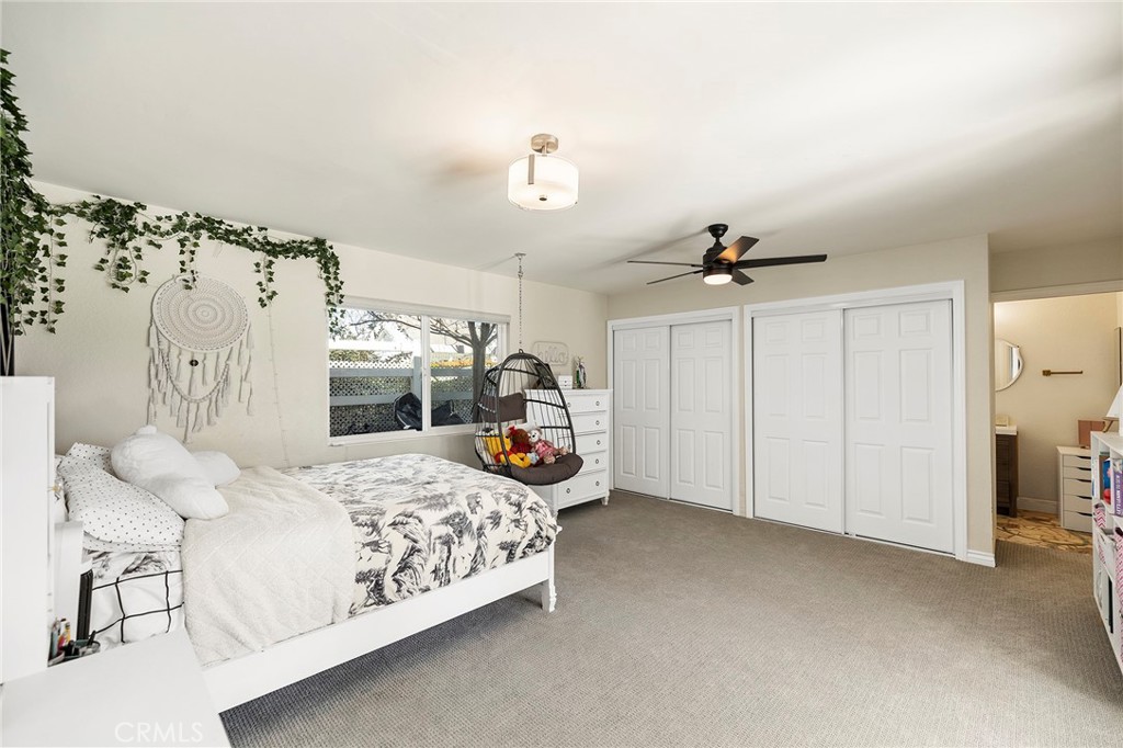 41480 Luz Del Sol Temecula, CA 92591 - Photo 24 of 44 a bedroom with a bed chandelier and a window