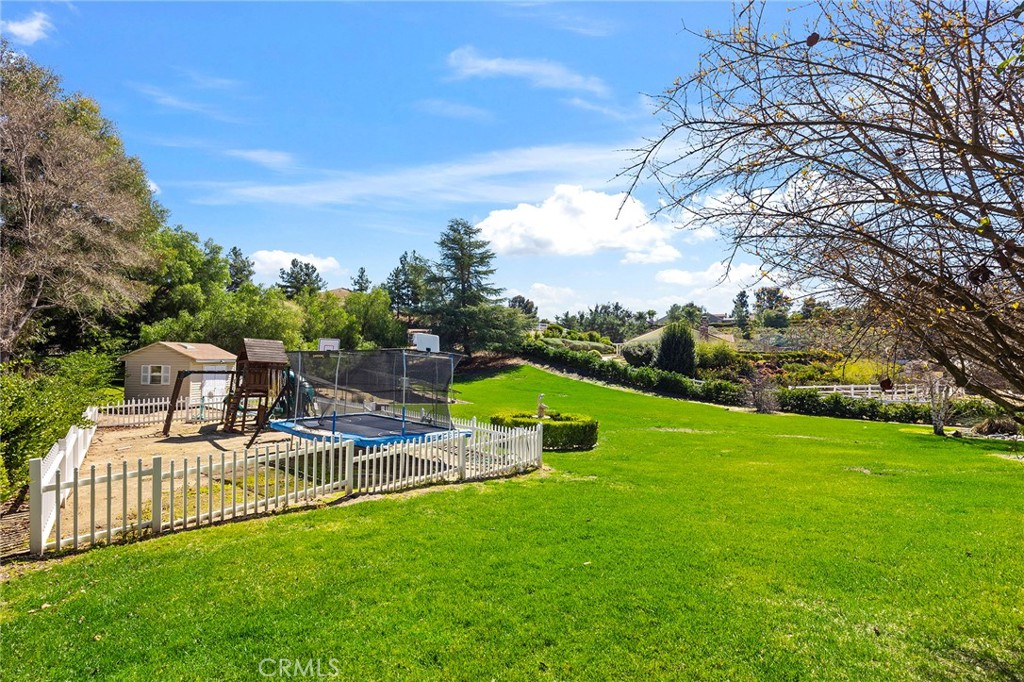 41480 Luz Del Sol Temecula, CA 92591 - Photo 43 of 44 a view of a house with a big yard and a fountain