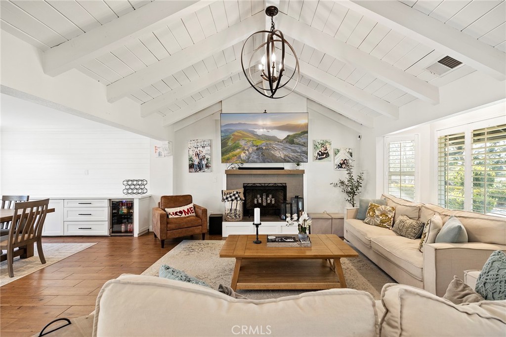41480 Luz Del Sol Temecula, CA 92591 - Photo 7 of 44 a living room with furniture a chandelier a fireplace and a large window