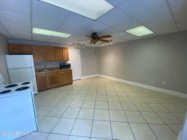a view of a kitchen with a sink and a stove top oven