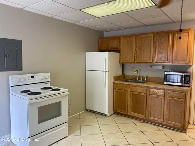a kitchen with a stove top oven and cabinets