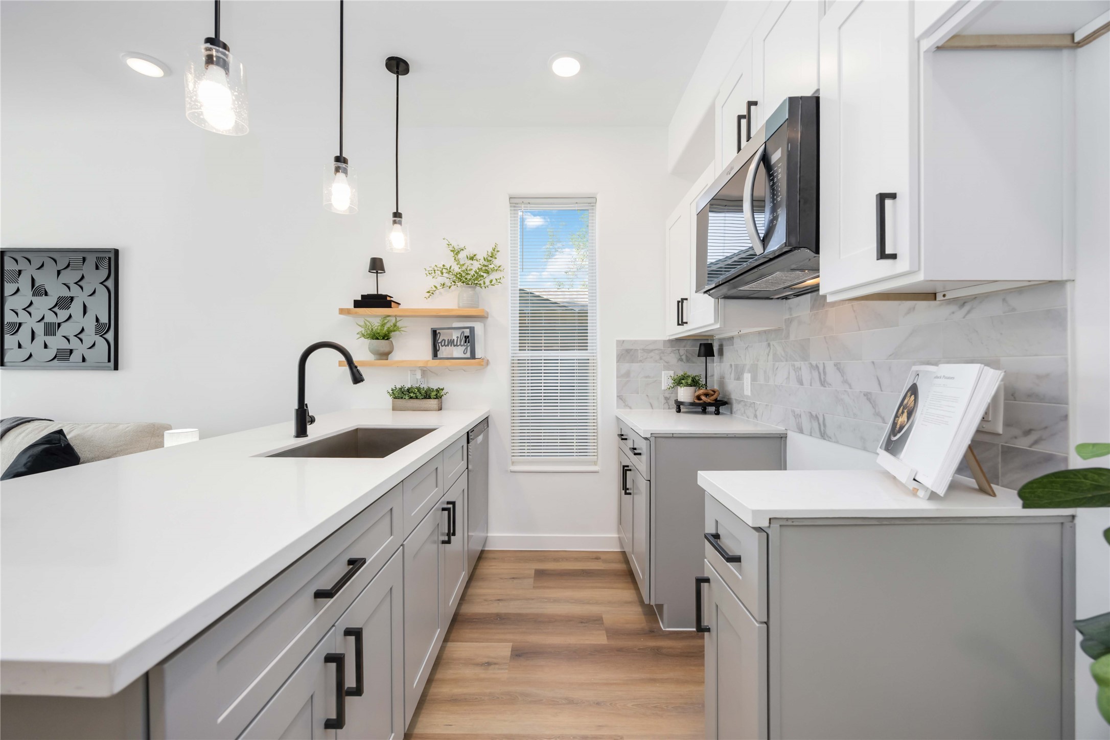 5811 Senior Street, Unit A Houston, TX 77016 - Photo 4 of 15 a kitchen with white cabinets and sink