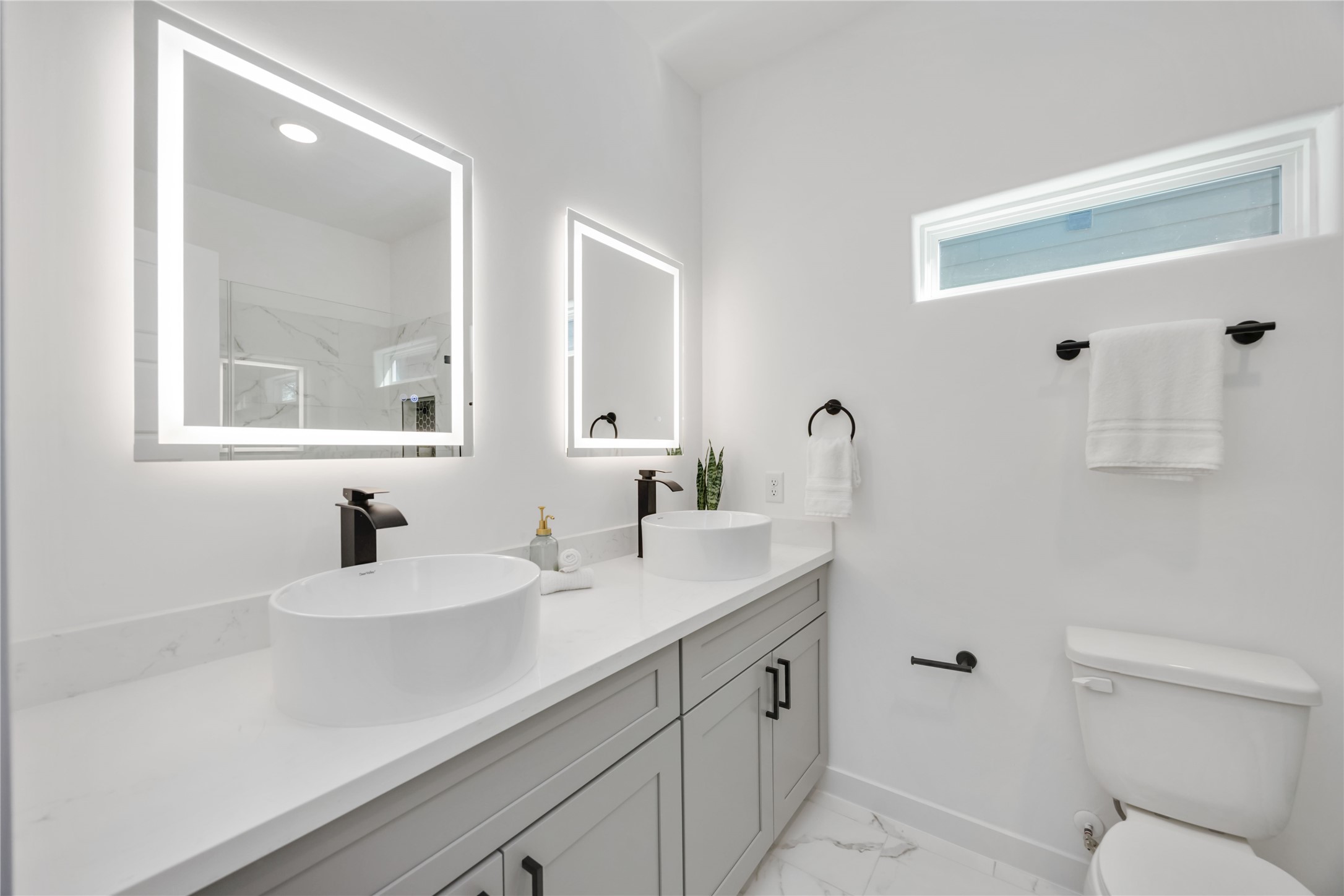 5811 Senior Street, Unit A Houston, TX 77016 - Photo 8 of 15 a bathroom with a sink a toilet and a mirror