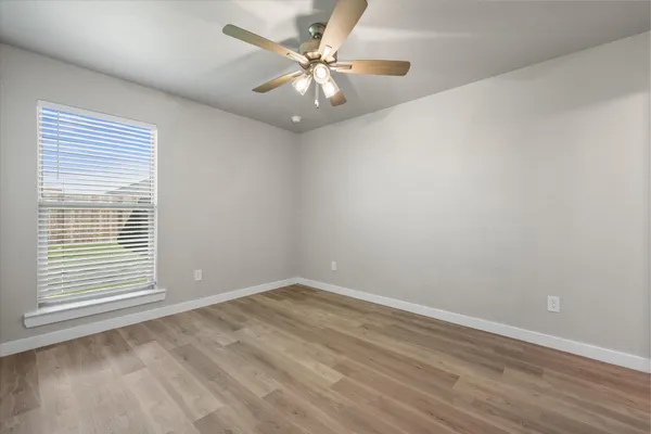 a view of an empty room and wooden floor