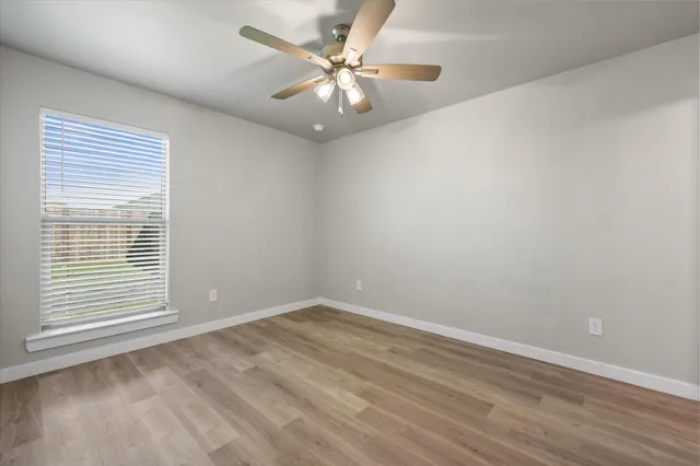 a view of an empty room and wooden floor