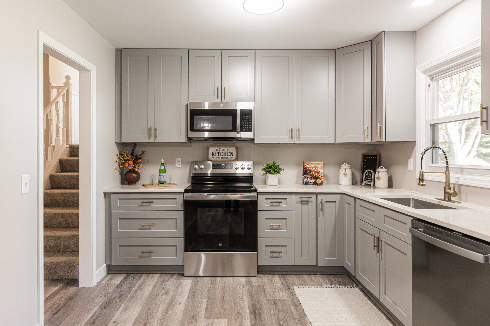 21044 Virginia Road DeKalb, IL 60115 - Photo 12 of 58 a kitchen with stainless steel appliances a stove sink and cabinets
