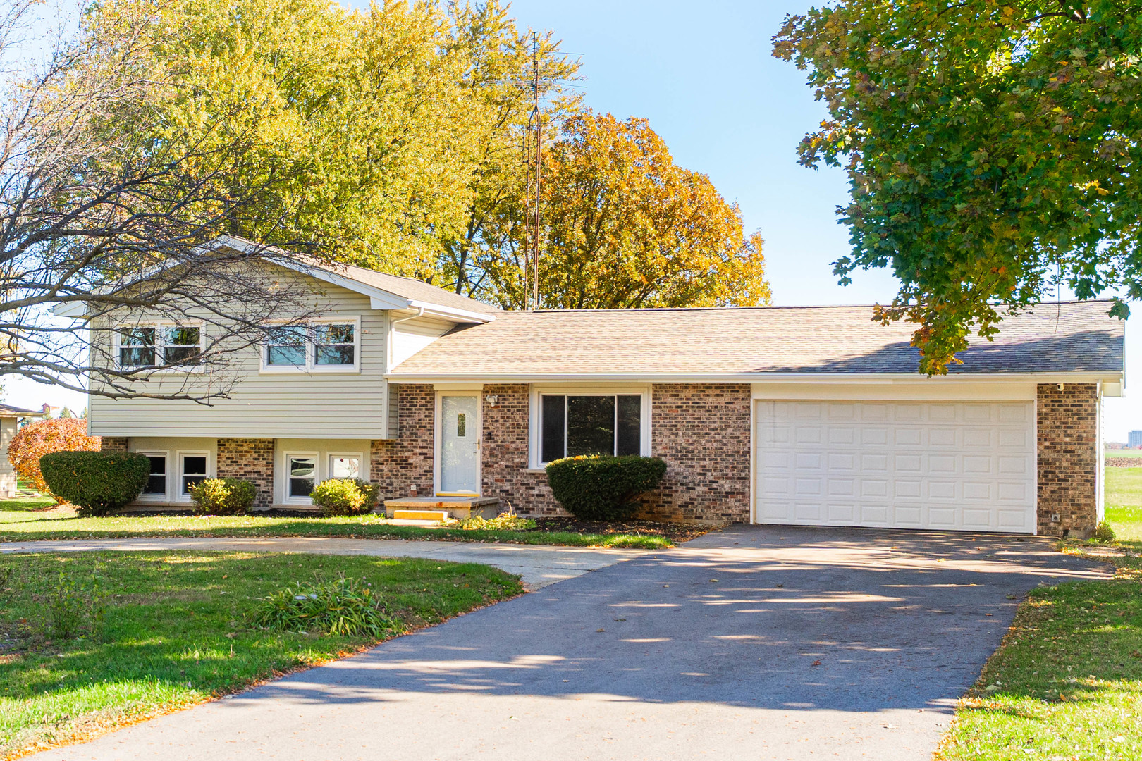 21044 Virginia Road DeKalb, IL 60115 - Photo 2 of 58 a front view of a house with a yard and garage