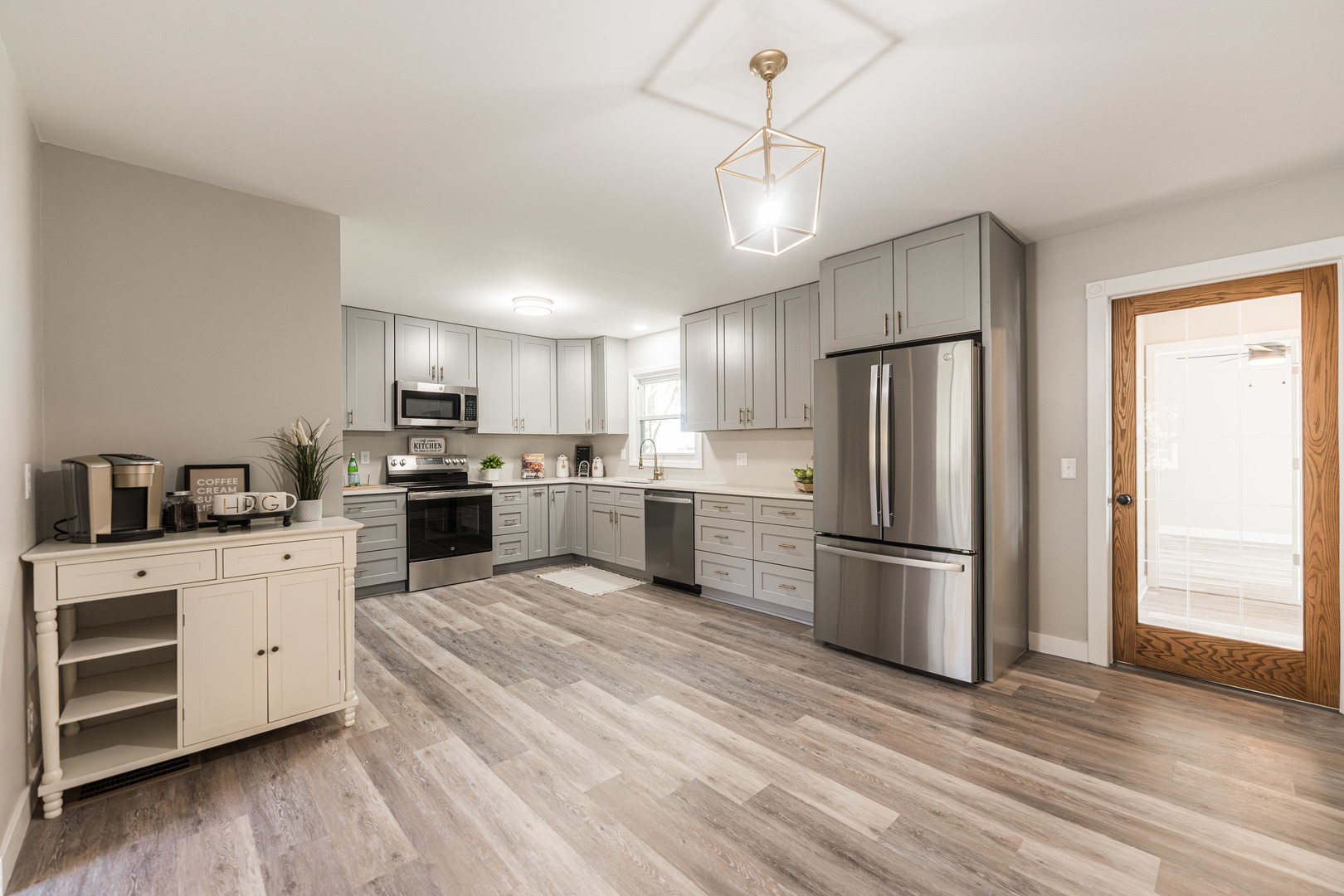 21044 Virginia Road DeKalb, IL 60115 - Photo 23 of 58 a kitchen with granite countertop a refrigerator a stove a sink cabinets and wooden floor