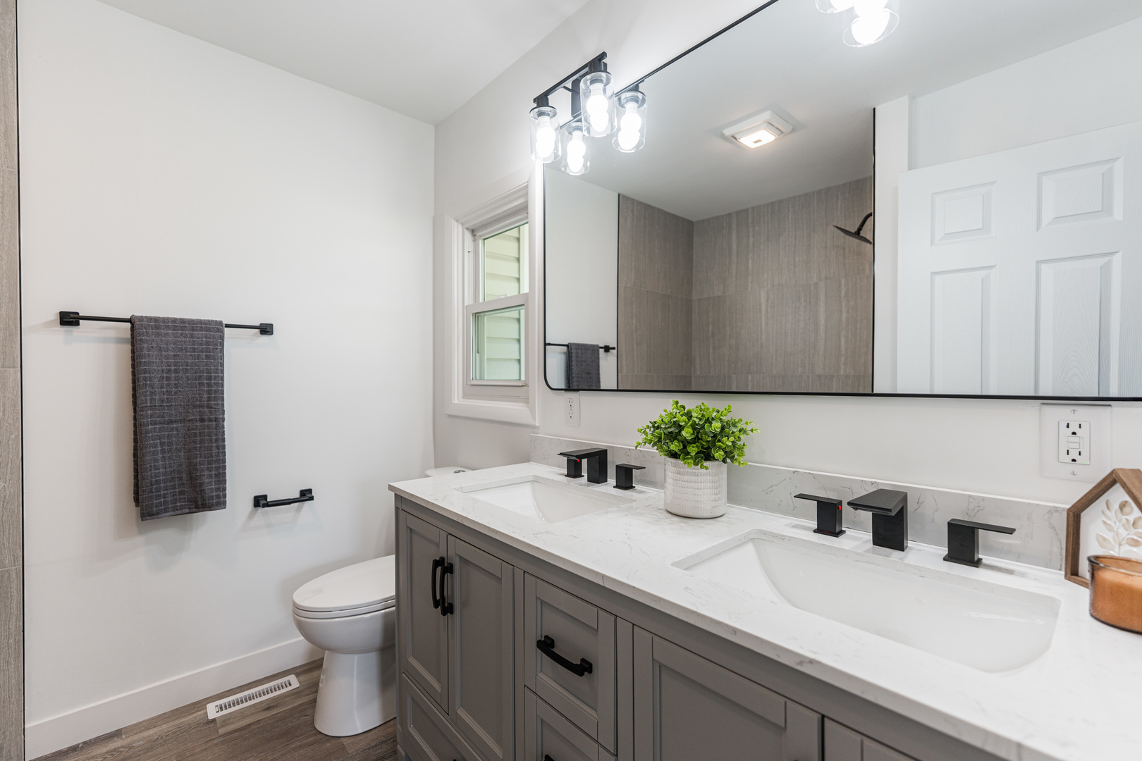 21044 Virginia Road DeKalb, IL 60115 - Photo 31 of 58 a bathroom with a sink and a mirror