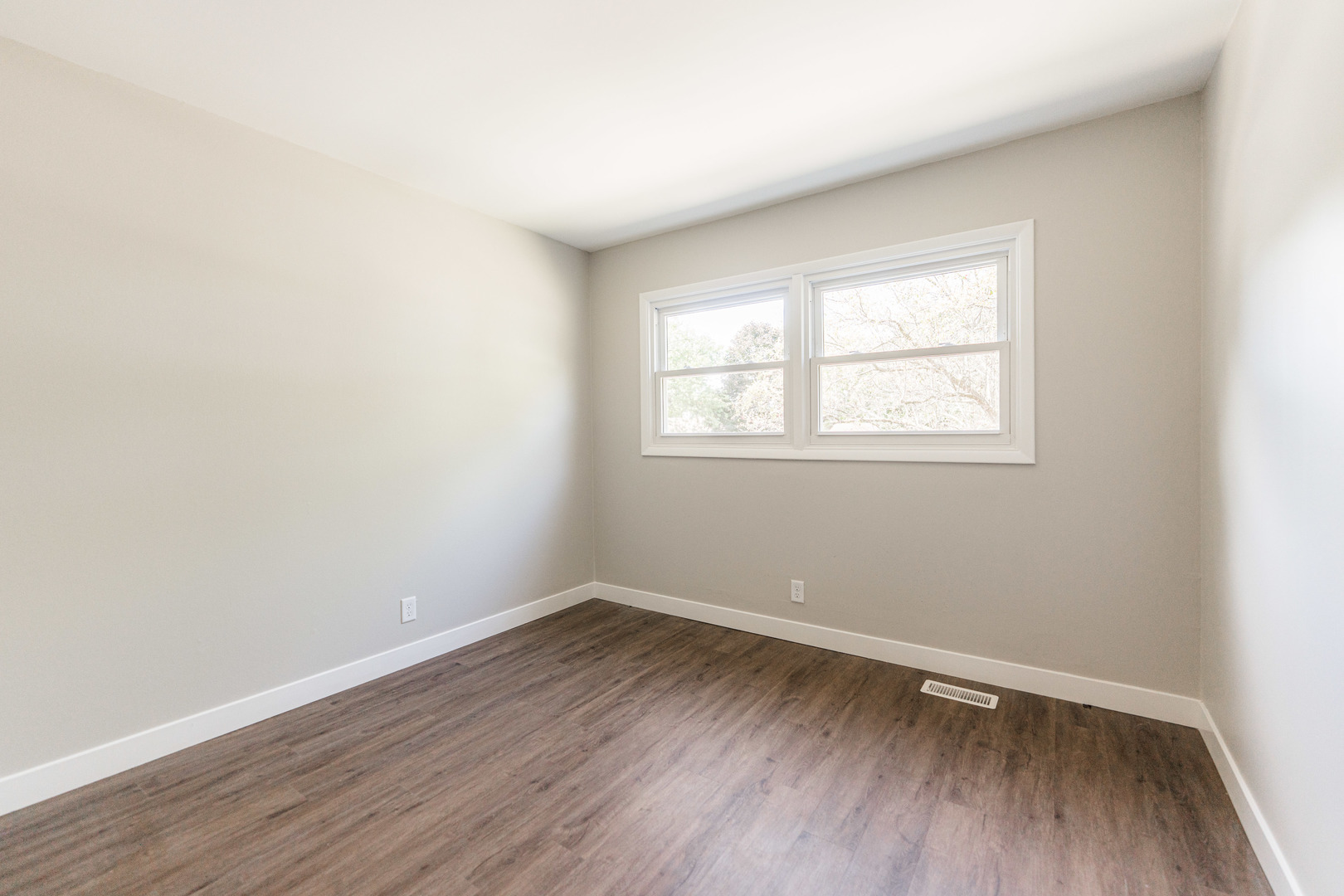 21044 Virginia Road DeKalb, IL 60115 - Photo 36 of 58 an empty room with wooden floor and windows