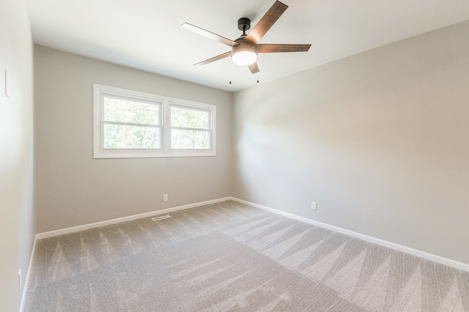 21044 Virginia Road DeKalb, IL 60115 - Photo 41 of 58 an empty room with windows and ceiling fan