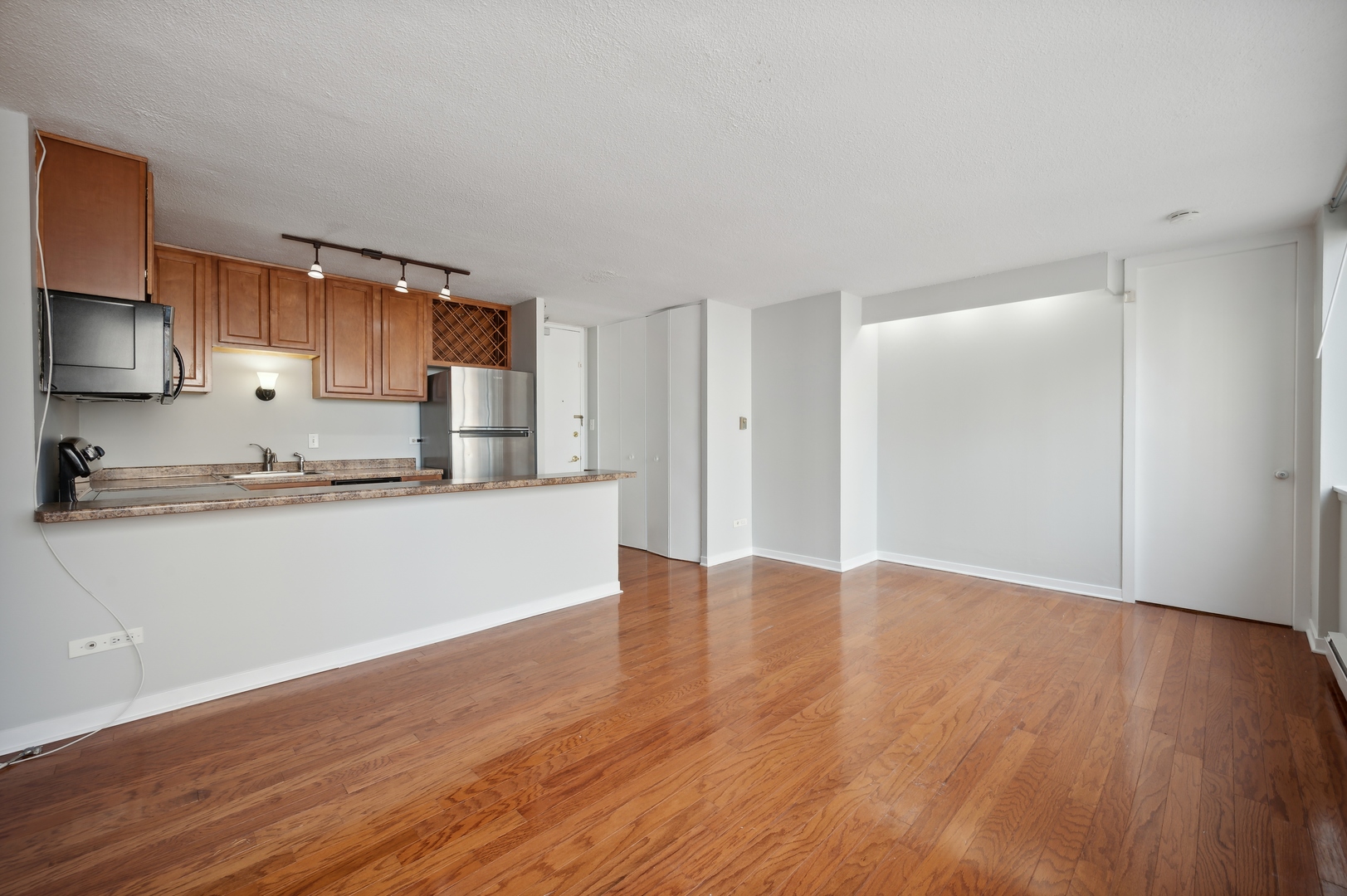 3110 North Sheridan Road, Unit 904 Chicago, IL 60657 - Photo 2 of 12 a view of kitchen with wooden floor
