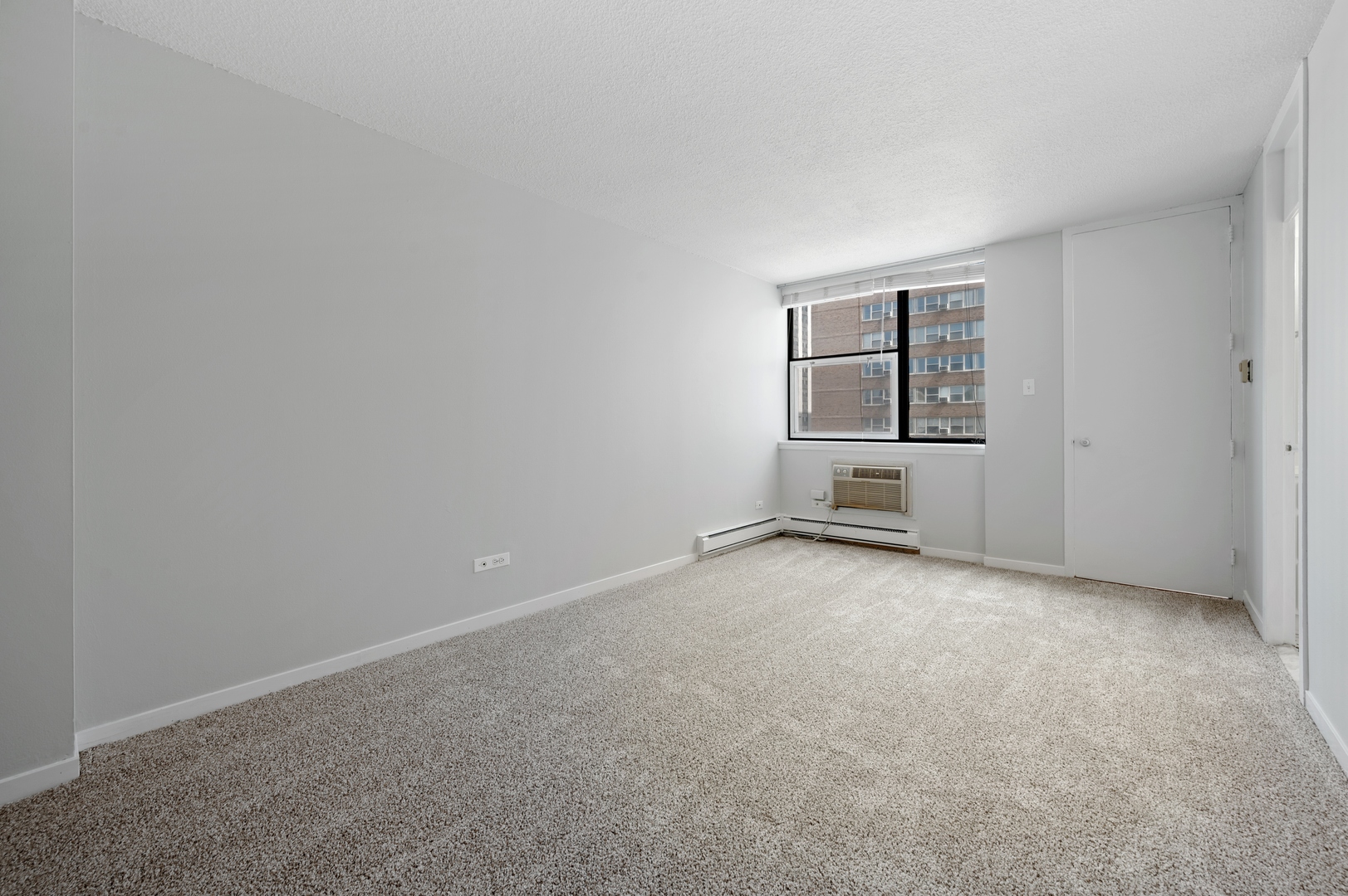 3110 North Sheridan Road, Unit 904 Chicago, IL 60657 - Photo 7 of 12 an empty room with windows and closet