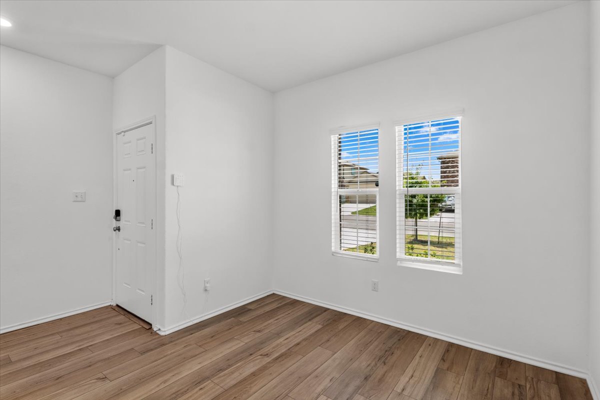 448 Perfect World Loop Jarrell, TX 76537 - Photo 21 of 40 Warm wood-look flooring extends throughout this versatile entry area, illuminated by twin windows offering street views.