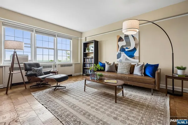 a living room with furniture a rug and a window