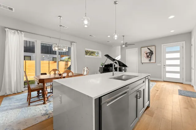 a kitchen with a stove a table and chairs