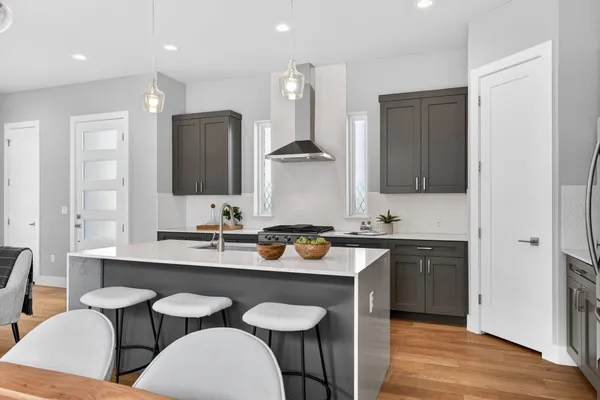 a kitchen with a sink cabinets and wooden floor