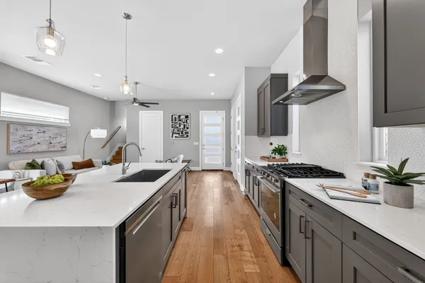 a kitchen with a sink a stove and chairs