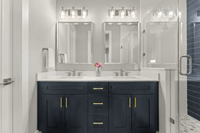 a bathroom with double sink and a mirror