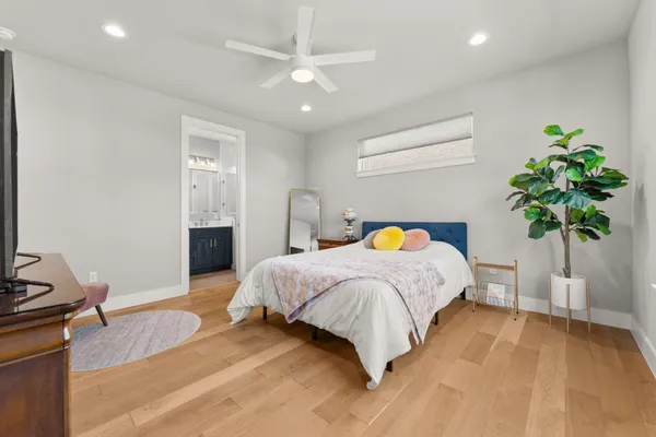 a bedroom with a bed and a potted plant