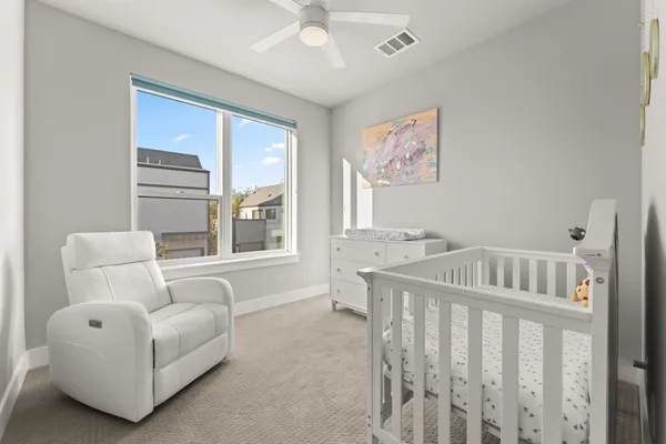 a bedroom with furniture and a large window