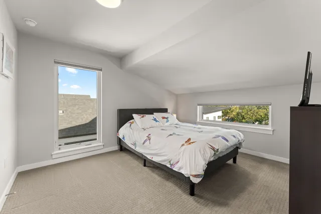 a bed sitting in a room next to a window