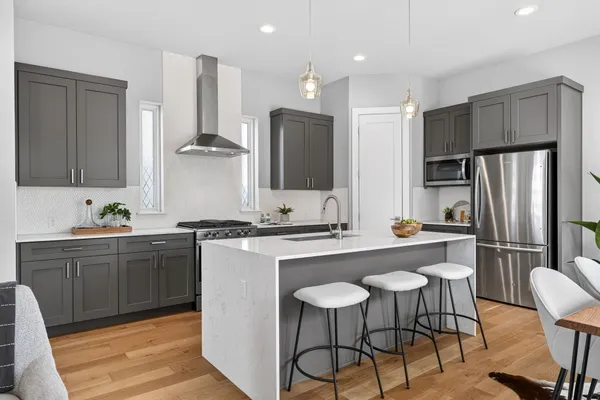 a kitchen with stainless steel appliances a sink and a refrigerator