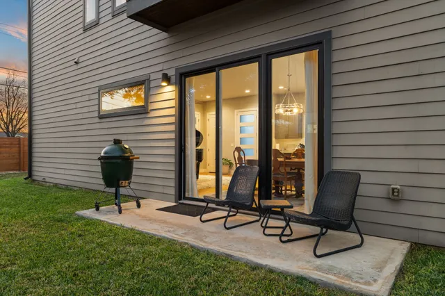 a view of a patio with a table and chairs
