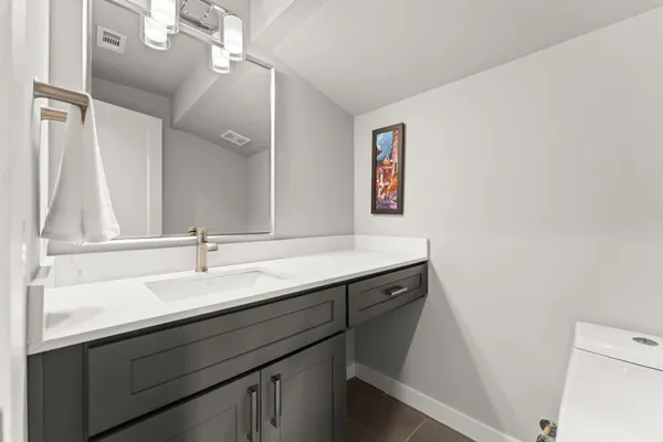 a bathroom with a sink a mirror and a toilet