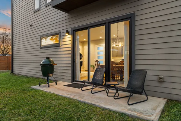a view of a patio with a table and chairs