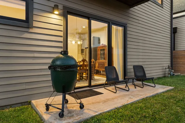 a view of a porch with chairs and potted plants