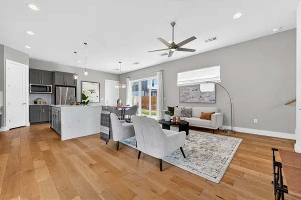 a living room with furniture and kitchen view