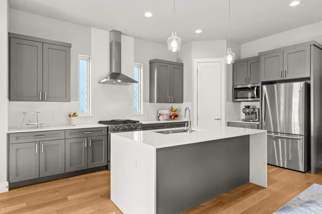 a kitchen with stainless steel appliances granite countertop a sink stove and refrigerator