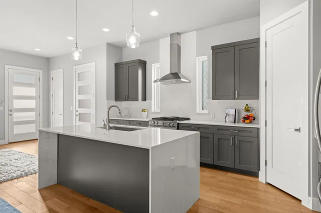 a large kitchen with kitchen island a sink stainless steel appliances and cabinets