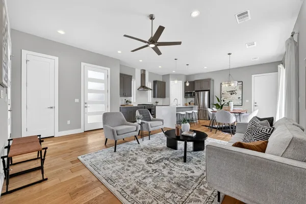 a living room with furniture and wooden floor