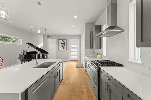 a kitchen with granite countertop a sink and stove