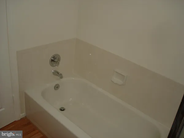 a bath tub sitting next to a white sink