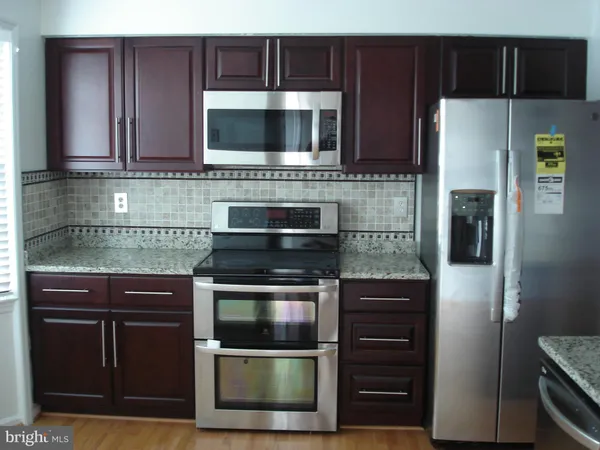 a kitchen with stainless steel appliances and cabinets