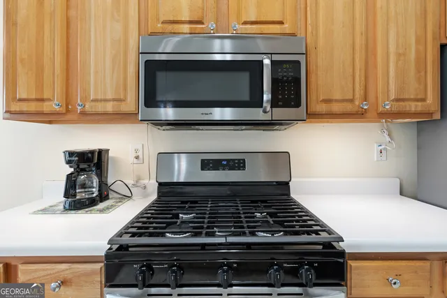 a stove top oven sitting inside of a kitchen