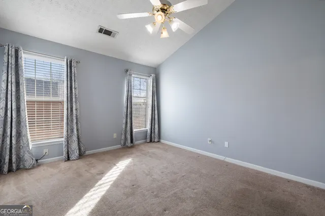 a view of a livingroom with a ceiling fan and window