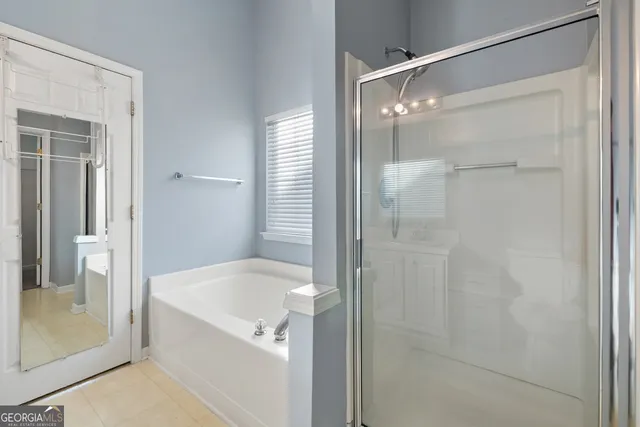 a bathroom with a bathtub and a shower
