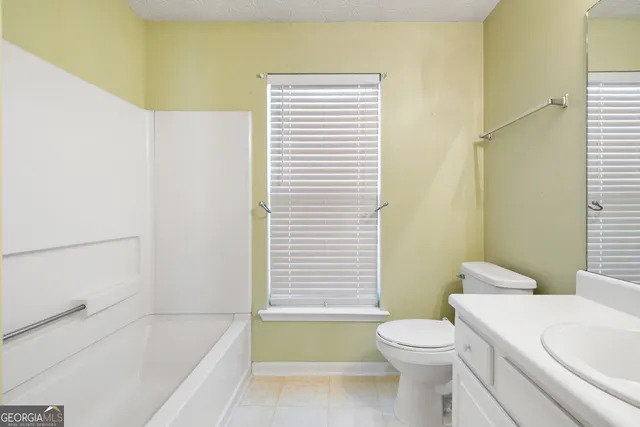 a bathroom with a toilet a sink and bathtub