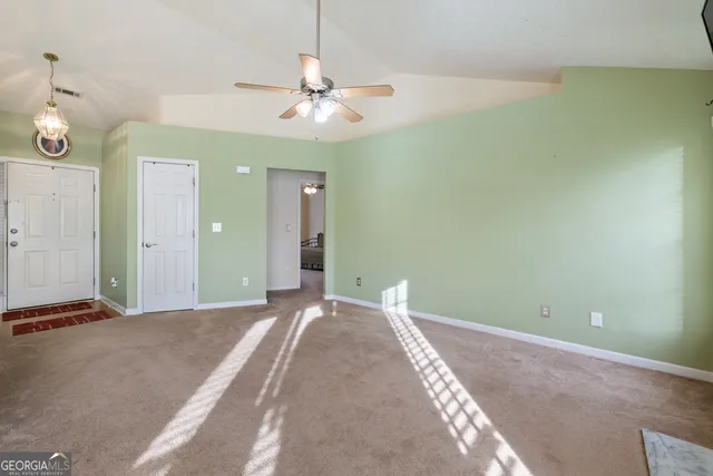 a view of a livingroom with a chandelier fan