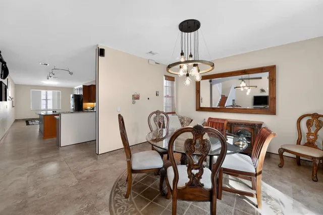 a view of a dining room with furniture and chandelier