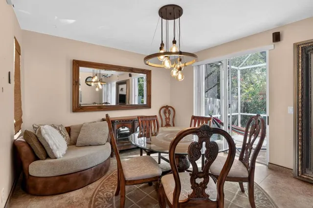 a view of a dining room with furniture wooden floor and chandelier