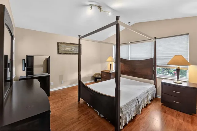 a spacious bedroom with a bed and a walk in closet