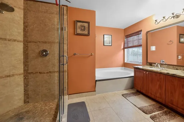 a bathroom with a tub shower and sink