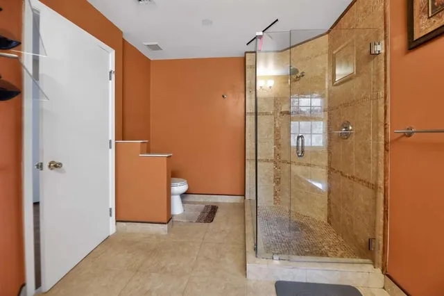 a bathroom with a glass shower door
