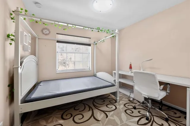 a bedroom with furniture and a window