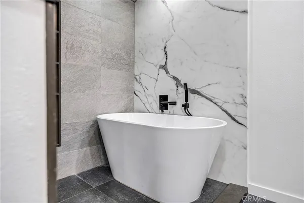 a white bath tub sitting in a bathroom